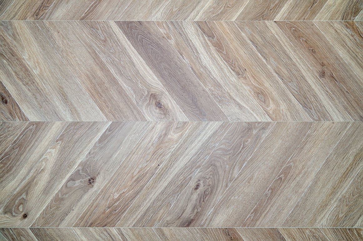 Texture of wood flooring. Herringbone wood floor. Parquet made of bleached oak.